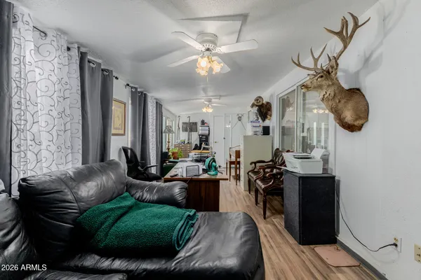 a living room with furniture a chandelier and a window
