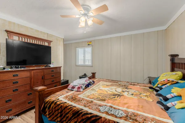 a bedroom with a bed and a flat screen tv