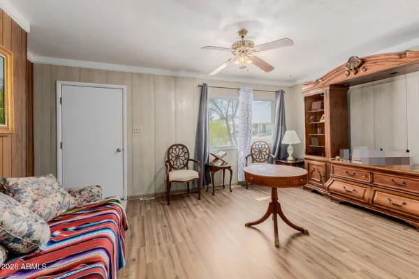 a bedroom with furniture and a wooden floor