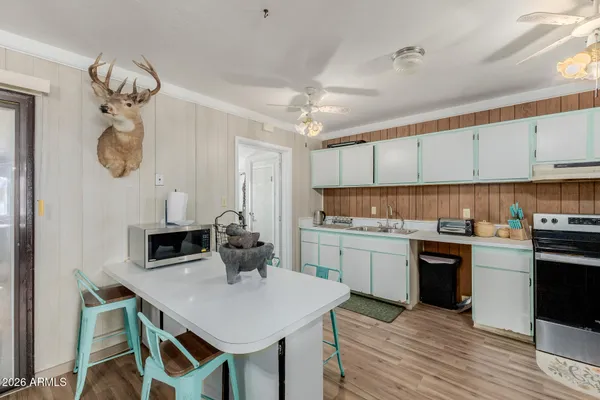 a kitchen with a center island appliances and cabinets