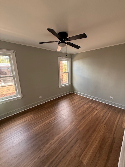 8204 South Elizabeth Street, Unit 2 Chicago, IL 60620 - Photo 6 of 11 an empty room with wooden floor and windows