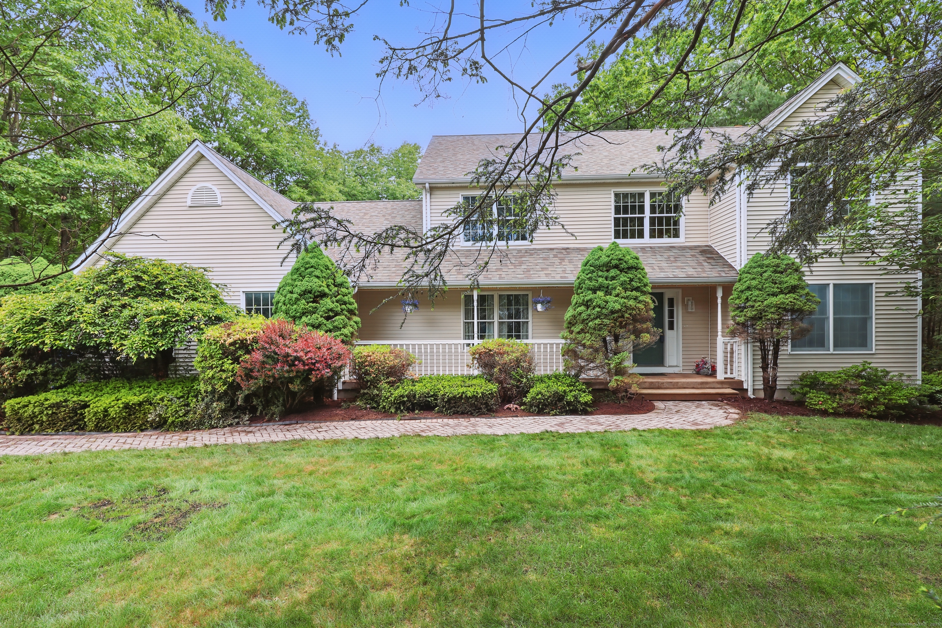 12 Silversmith Road Farmington, CT 06085 - Photo 1 of 1 a front view of a house with a garden and plants