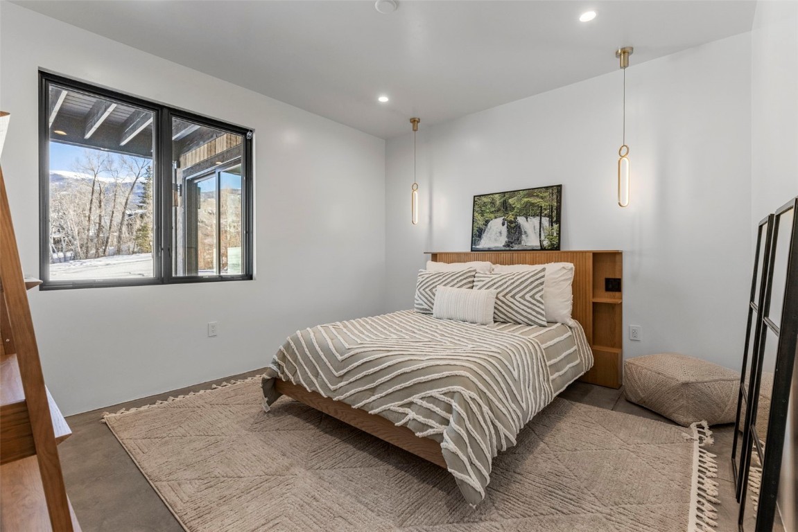 149 Game Trail Road Silverthorne, CO 80498 - Photo 32 of 49 a bedroom with a bed and a painting on the wall