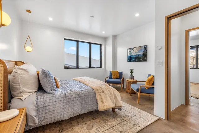 a bedroom with a large bed and a window