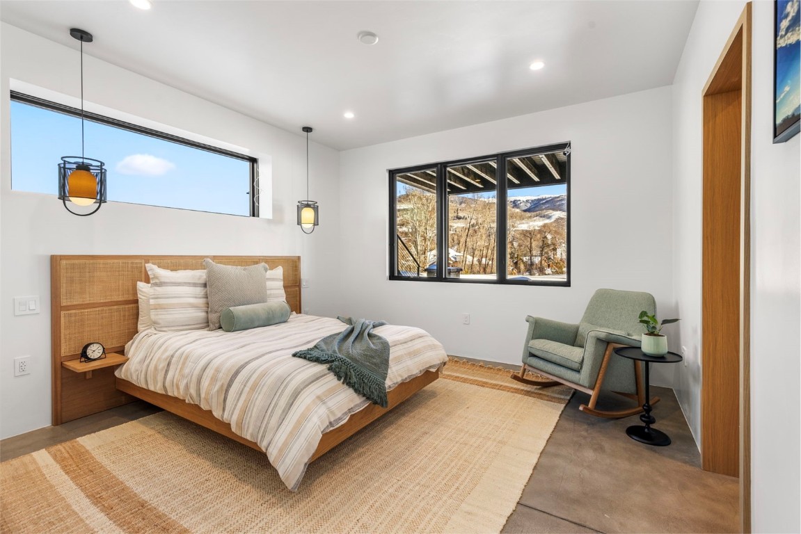 149 Game Trail Road Silverthorne, CO 80498 - Photo 37 of 49 a bedroom with a large bed and a window