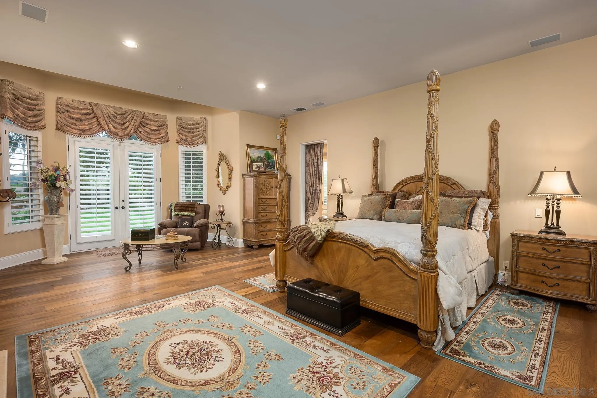 14725 Rancho Santa Fe Farms Road Rancho Santa Fe, CA 92067 - Photo 12 of 50 a spacious bedroom with a bed a table and chair