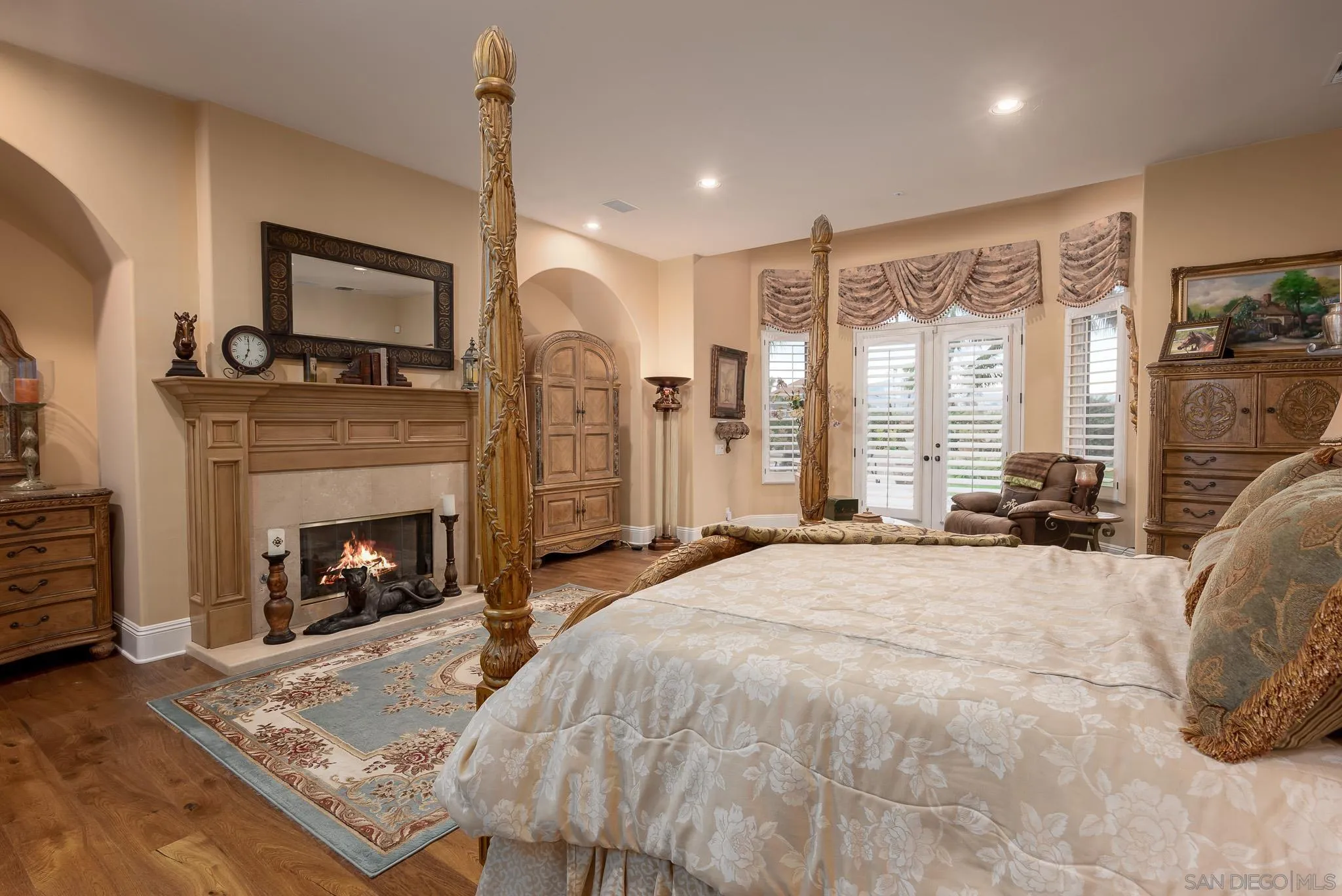 14725 Rancho Santa Fe Farms Road Rancho Santa Fe, CA 92067 - Photo 13 of 50 a large bedroom with a bed and a fireplace