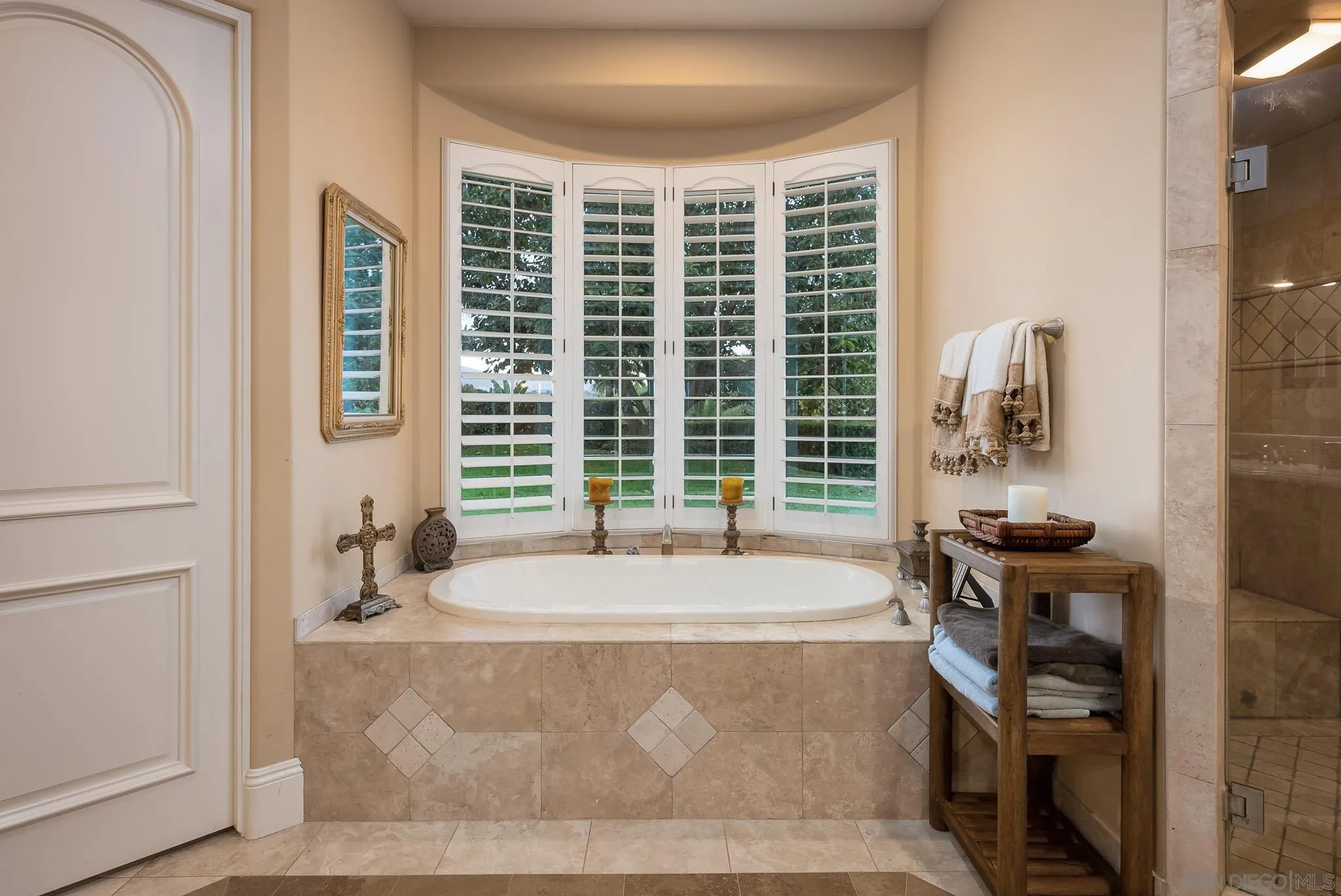 14725 Rancho Santa Fe Farms Road Rancho Santa Fe, CA 92067 - Photo 14 of 50 a spacious bathroom with a bathtub and next to a window
