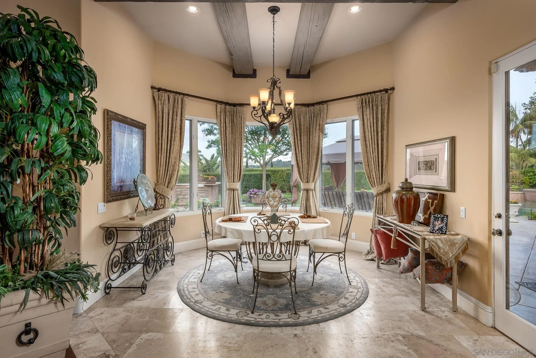 14725 Rancho Santa Fe Farms Road Rancho Santa Fe, CA 92067 - Photo 16 of 50 a dining room with furniture a chandelier and window