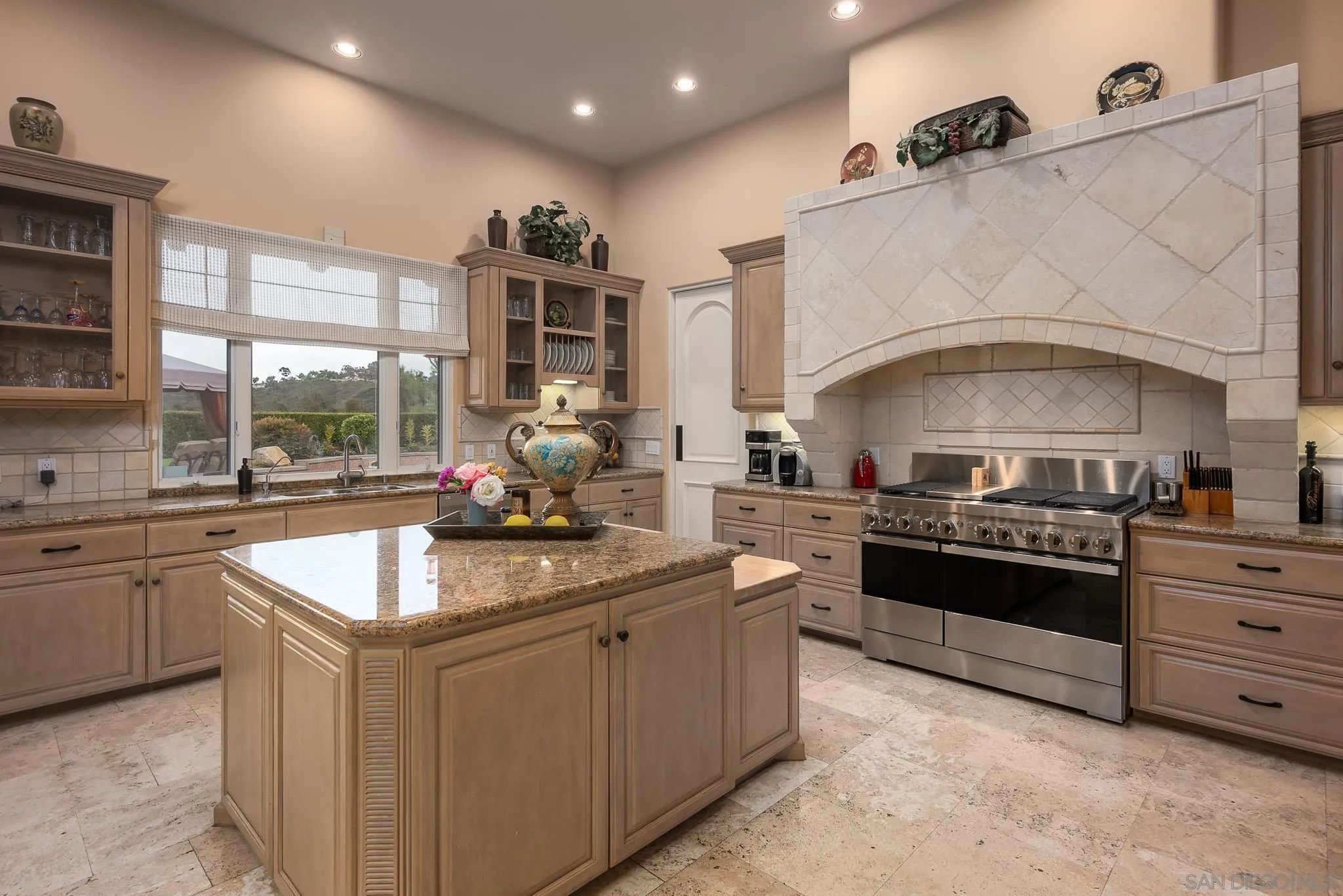 14725 Rancho Santa Fe Farms Road Rancho Santa Fe, CA 92067 - Photo 21 of 50 a kitchen with stainless steel appliances granite countertop a sink and stove