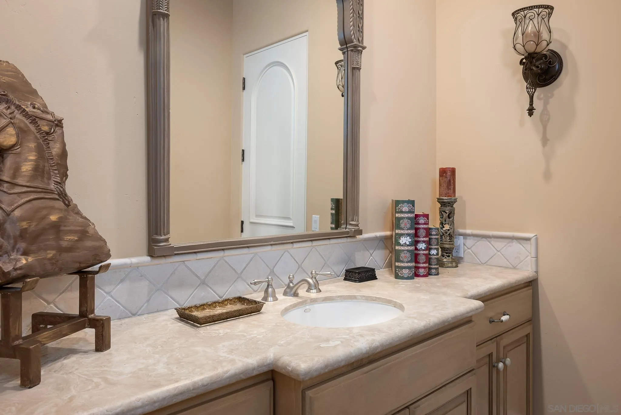 14725 Rancho Santa Fe Farms Road Rancho Santa Fe, CA 92067 - Photo 24 of 50 a bathroom with a granite countertop sink and a mirror