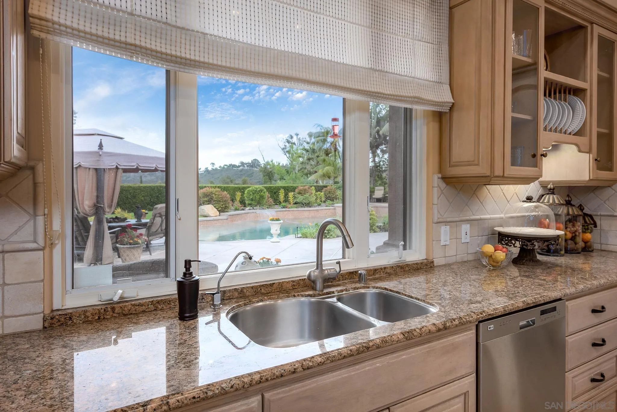 14725 Rancho Santa Fe Farms Road Rancho Santa Fe, CA 92067 - Photo 26 of 50 a kitchen with a granite countertop sink and natural light