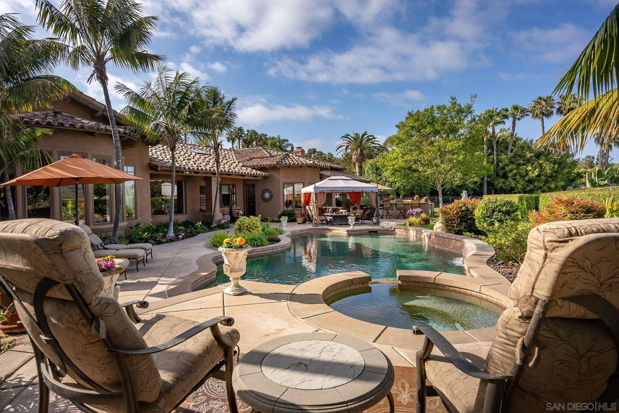 14725 Rancho Santa Fe Farms Road Rancho Santa Fe, CA 92067 - Photo 29 of 50 a view of a swimming pool and lounge chairs