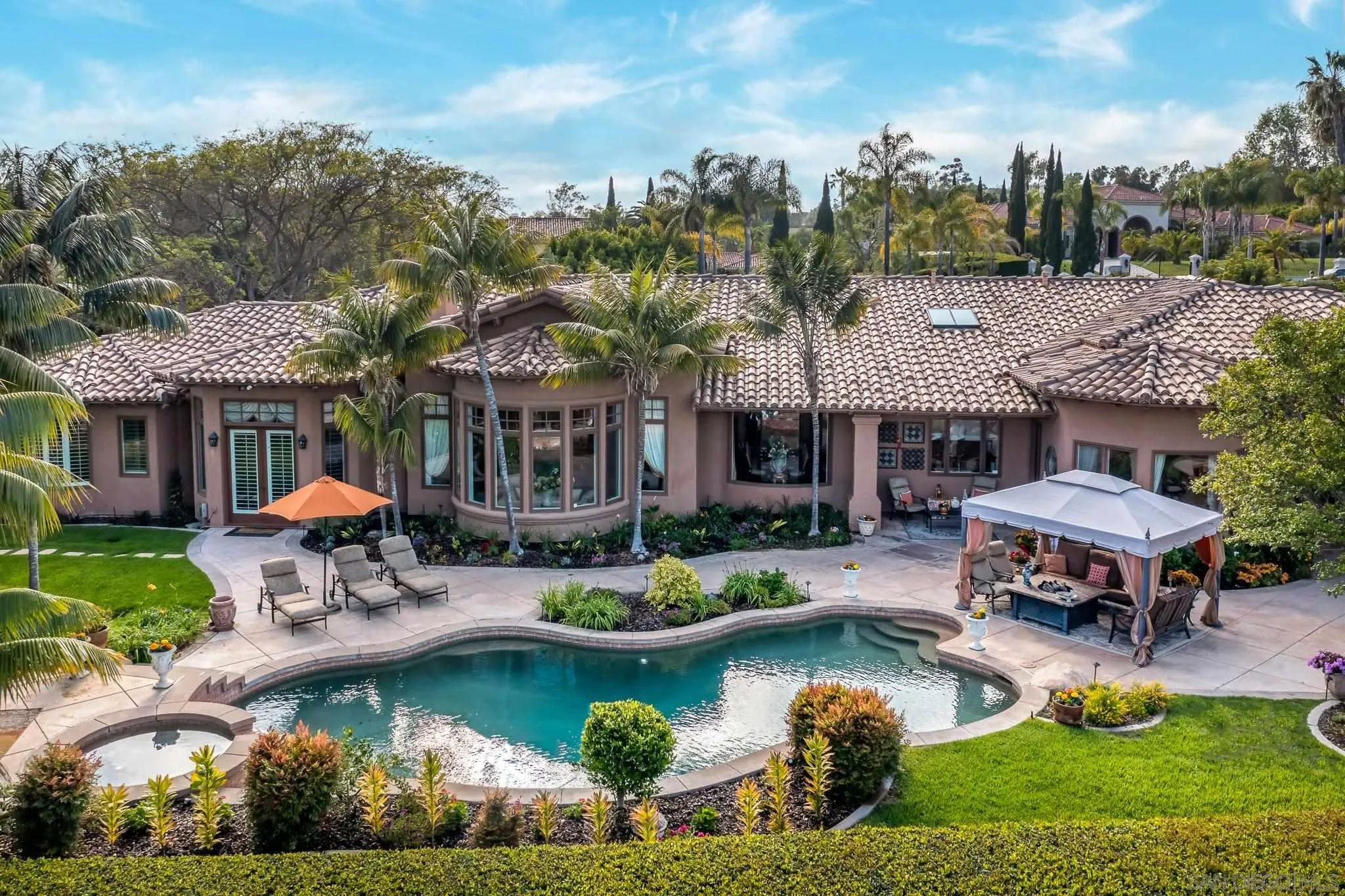 14725 Rancho Santa Fe Farms Road Rancho Santa Fe, CA 92067 - Photo 31 of 50 a view of a house with swimming pool and sitting area