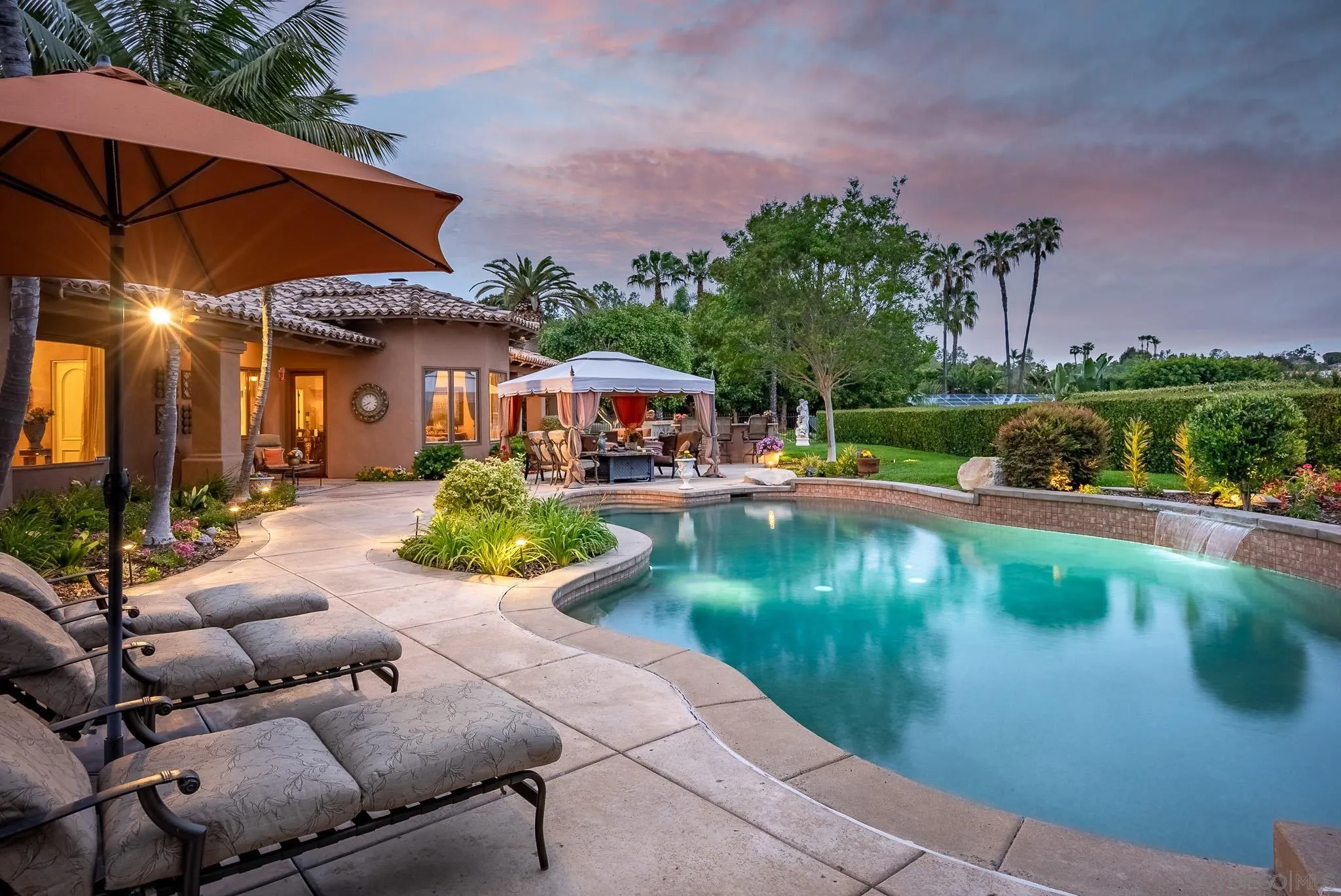14725 Rancho Santa Fe Farms Road Rancho Santa Fe, CA 92067 - Photo 38 of 50 an outdoor space with patio furniture and a garden