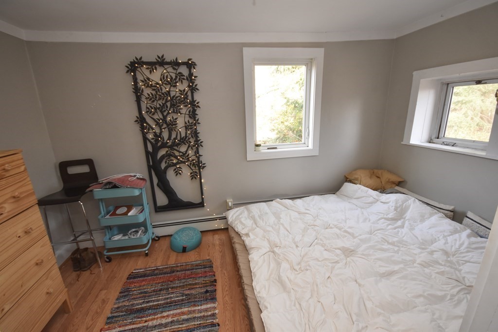 35 High Street Amherst, MA 01002 - Photo 27 of 41 a bedroom with a bed and wooden floor