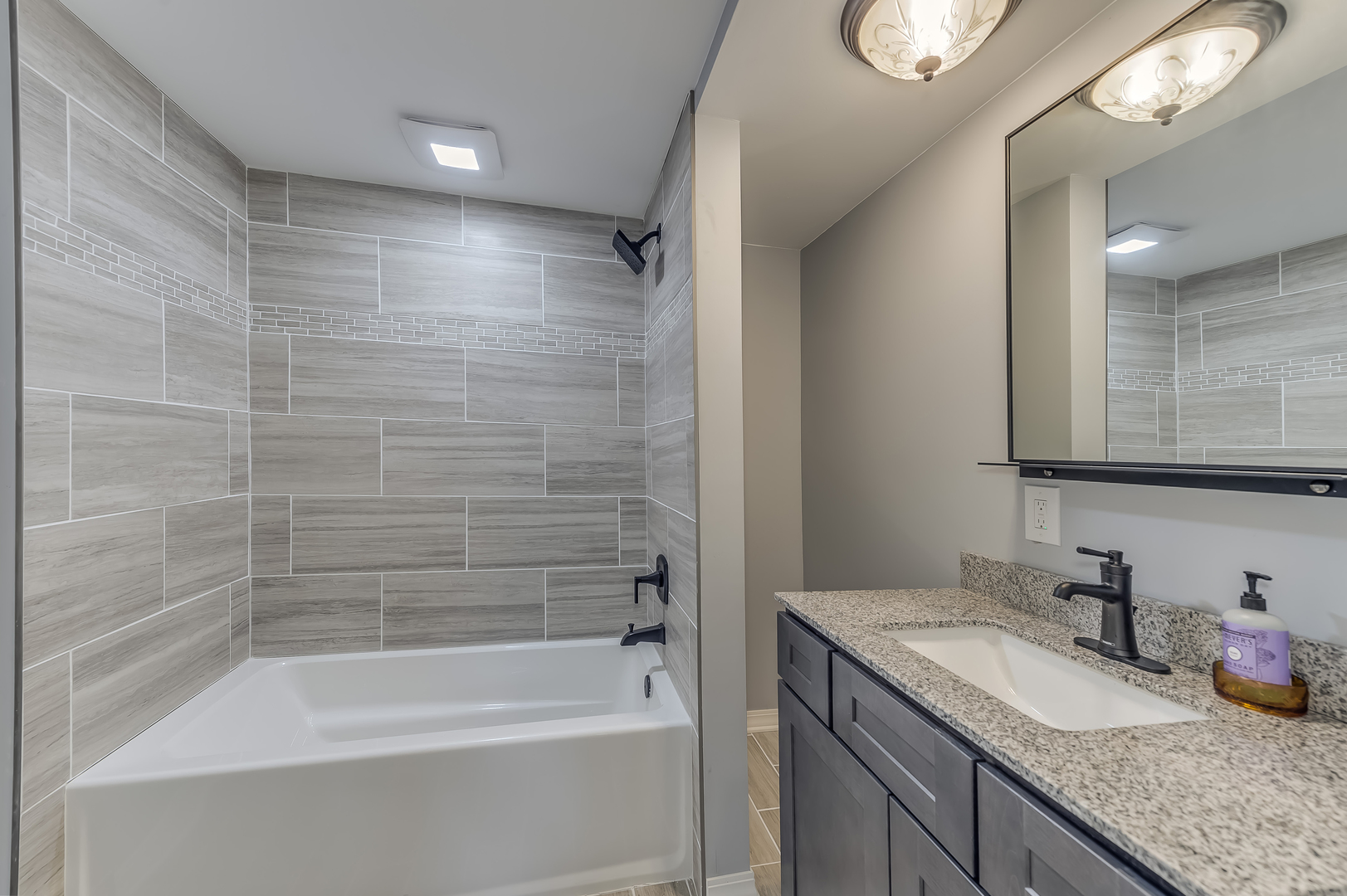 21136 Hillside Road Frankfort, IL 60423 - Photo 14 of 18 a bathroom with a granite countertop sink a mirror and a bathtub