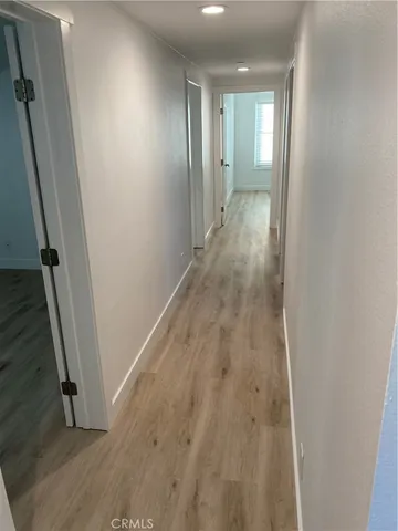 a view of hallway with wooden floor