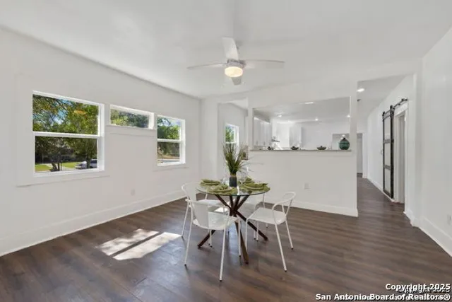 a view of a dining room with furniture and a window