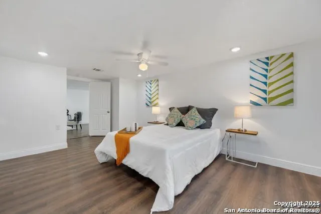 a bedroom with a bed and wooden floor