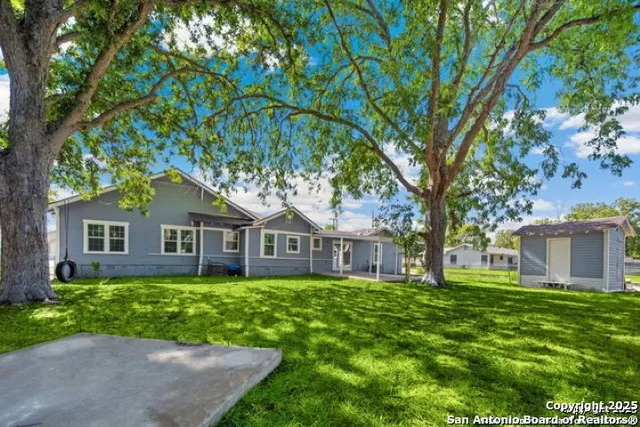 a front view of house with yard and green space