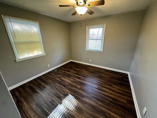 a view of room with wooden floor and window