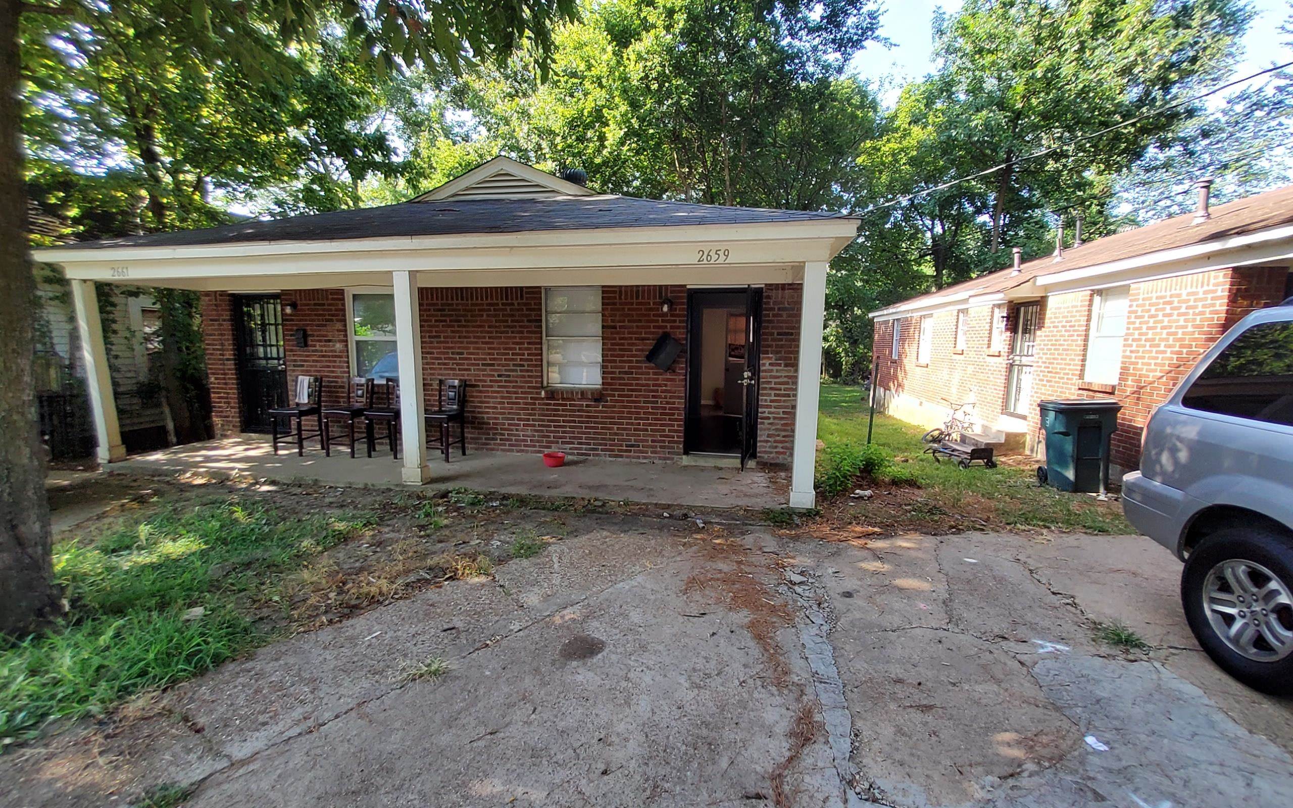 a view of a house with a yard and garage