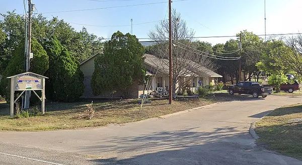 a backyard of a house with table and chairs