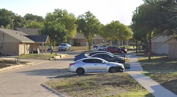 a view of cars parked on the side of a street