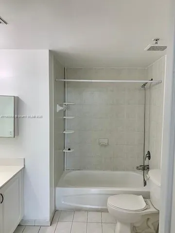 a view of a room with wooden floor and a window