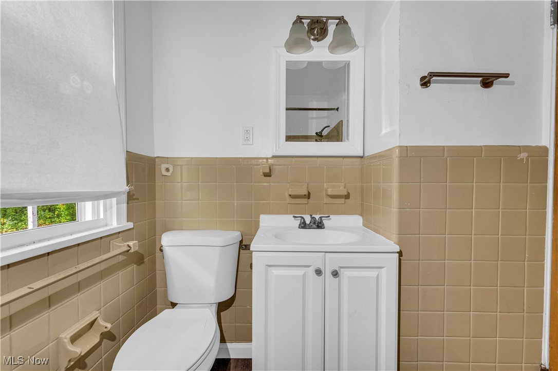 968 South Green Road Cleveland, OH 44121 - Photo 14 of 25 Bathroom featuring tile walls, vanity, and toilet