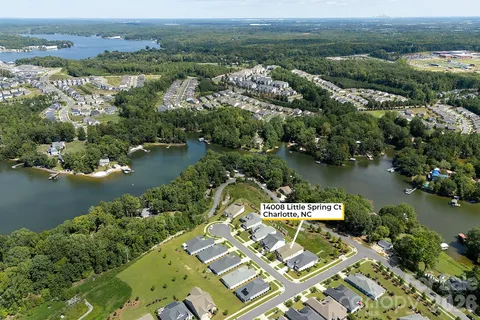 an aerial view of a house with a lake view