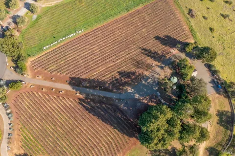 an aerial view of a house with a yard basket ball court and outdoor seating