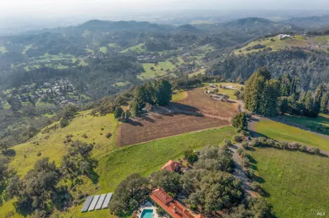an aerial view of a house with a yard