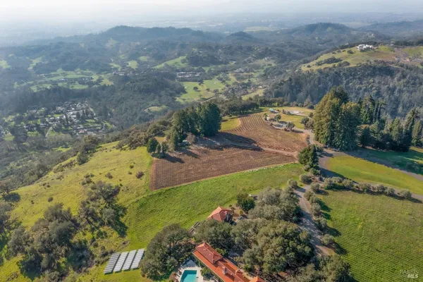 an aerial view of a house with a yard