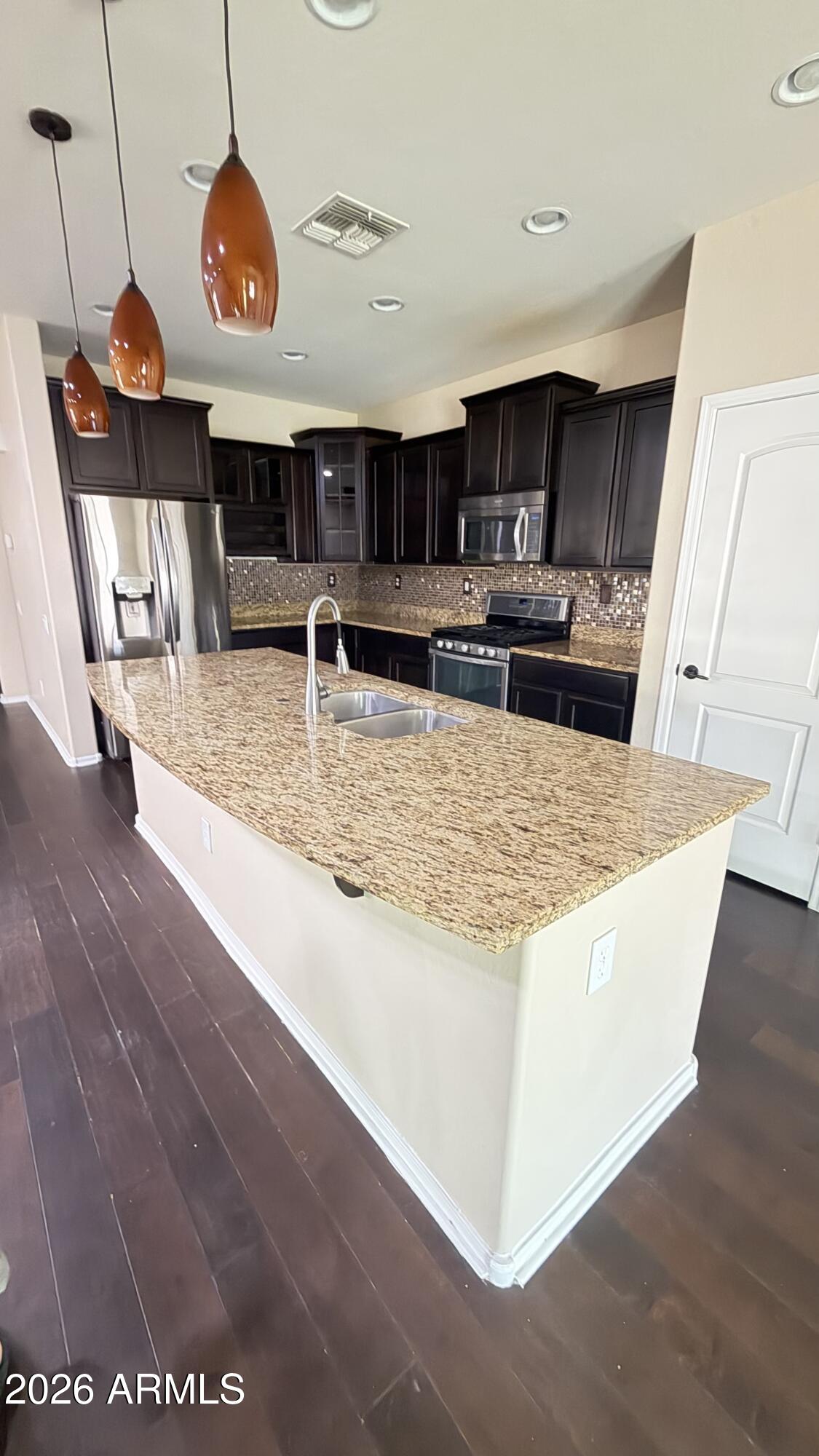 10786 West Yearling Road Peoria, AZ 85383 - Photo 3 of 21 a view of a living room and kitchen