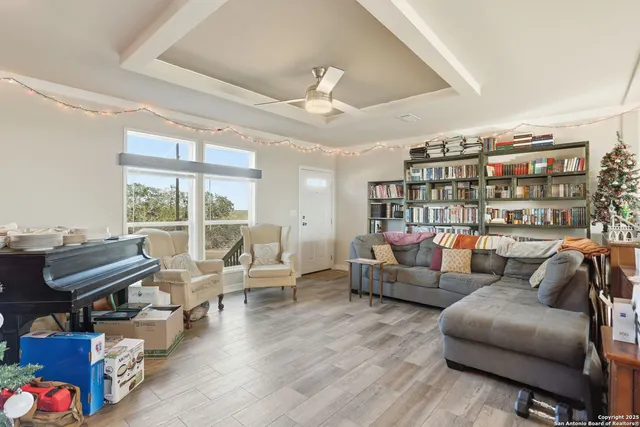 a living room with furniture a rug and a large window
