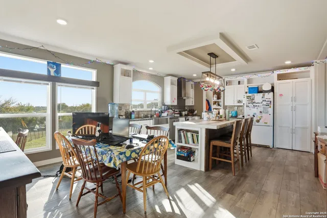 a dining area with furniture window and wooden floor