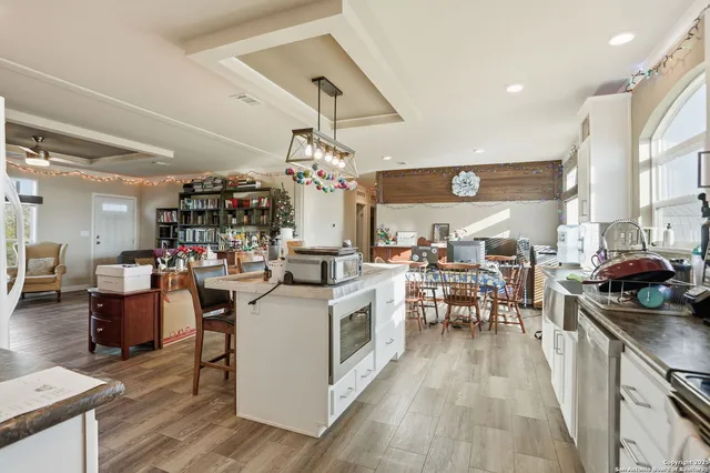 a view of kitchen with cabinets and wooden floor