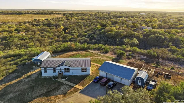 an aerial view of a house with a yard