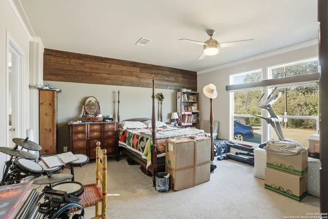 a bedroom with furniture and a large window