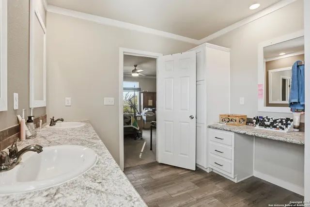 a en suite bathroom with a sink and a mirror