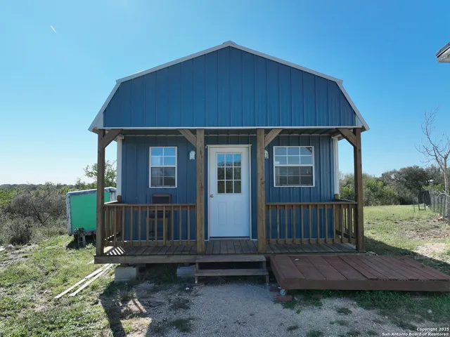 a view of a backyard with wooden fence