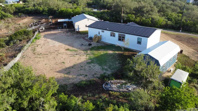 an aerial view of a house with a yard