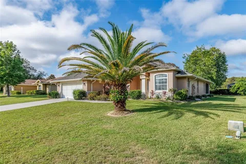 a view of house with outdoor space and garden