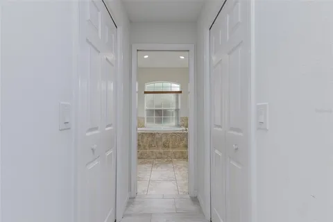 a view of empty room with fireplace and windows