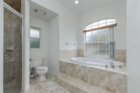 a view of an empty room with windows and a balcony