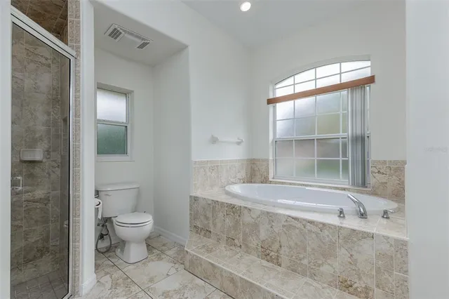 a view of an empty room with windows and a balcony