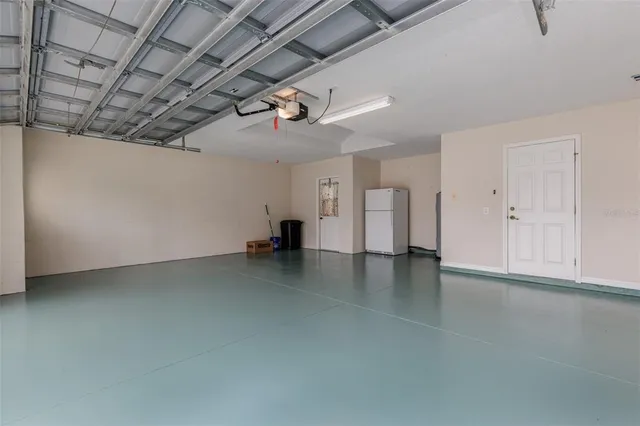 an aerial view of residential houses with outdoor space and street view