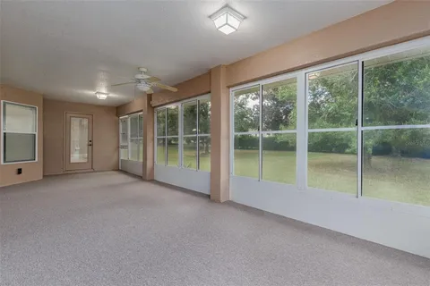 an aerial view of residential houses with outdoor space and trees